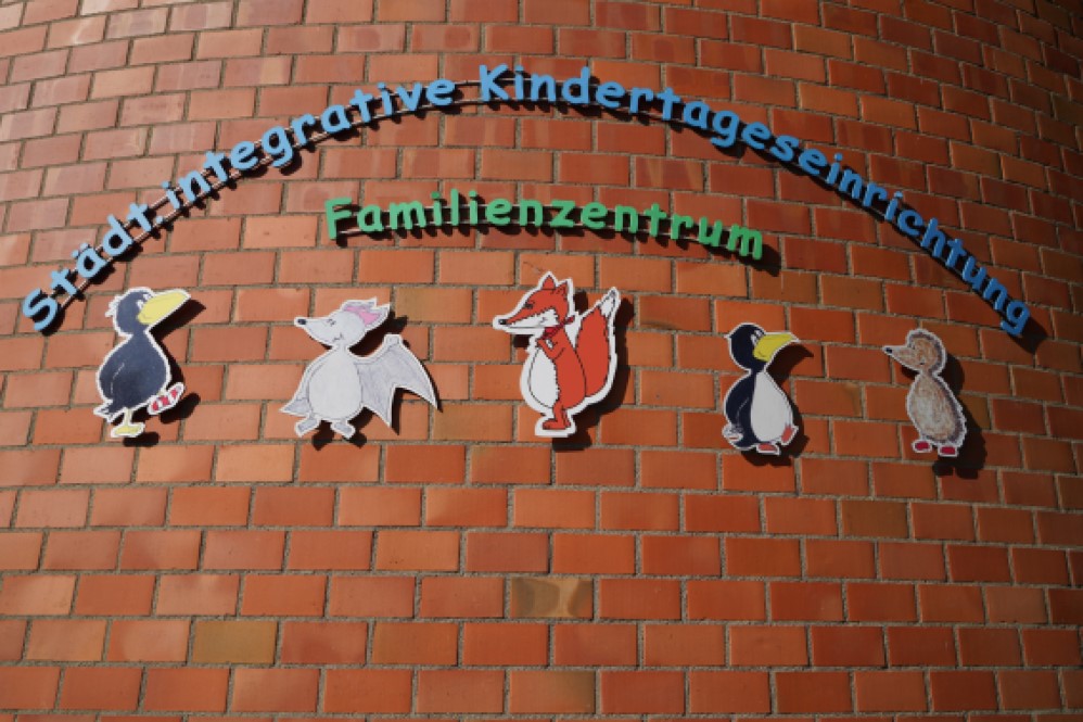 Unser buntes Logo mit den Gruppentieren am Eingang des Familienzentrums